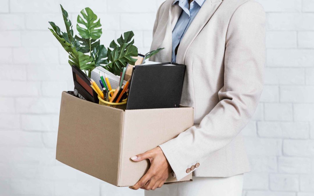 Unrecognizable black woman holding box of personal belongings, leaving office after losing her job, closeup of hands. Economic crisis and unemployment during covid-19 epidemic