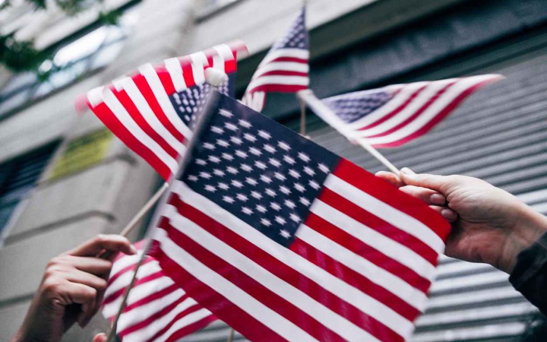 American flags raised in the air for Holiday celebrations