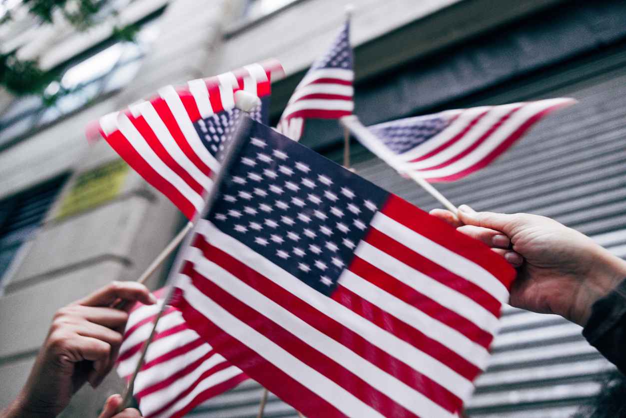 American flags raised in the air for Holiday celebrations