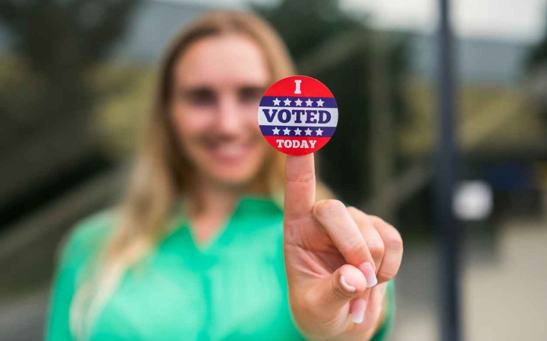 Woman holding a "I Voted Today" sticker. Election day concept.