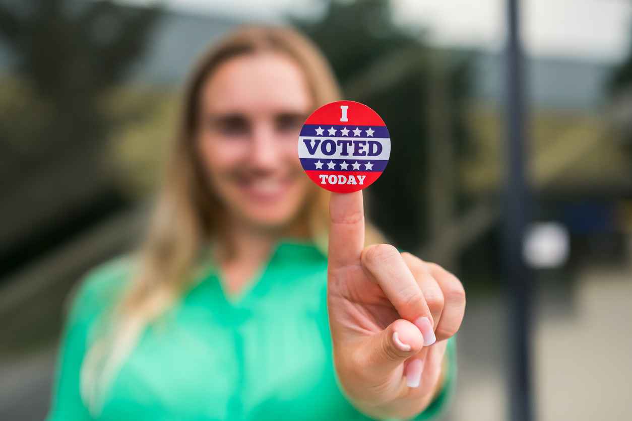 Woman holding a "I Voted Today" sticker. Election day concept.